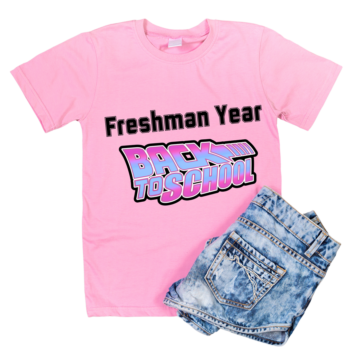 Pink t-shirt with 'Freshman Year' text and denim shorts on a white background